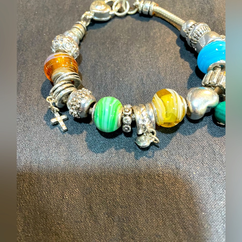 Pandora like bracelet rich in beads, star, cross and turquoise beads